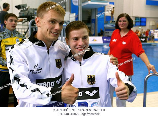 The Germans Martin Wolfram (R) and Oliver Homuth (L) give thumbs up after the men's finale in diving from the one metre board at the European Diving...