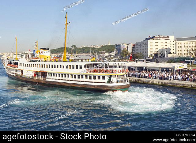 Istanbul, Istanbul Province, Turkey. Ferry docking at Eminonu pier to pick up rush hour commuters