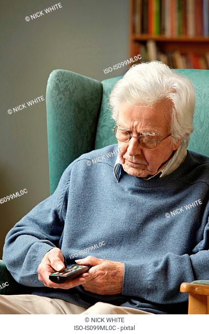 Senior man using remote control