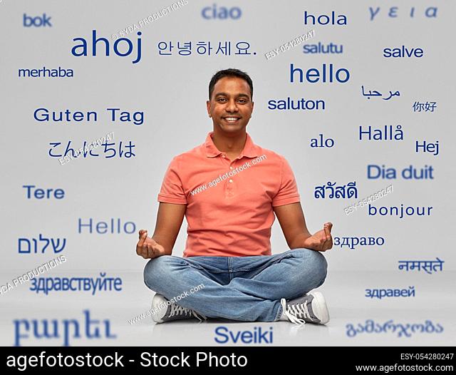 happy indian man over words in foreign languages