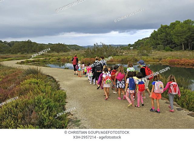 children walking around in the lagoon of s'Albufera des Grau Natural Park, Menorca, Balearic Islands, Spain, Europe