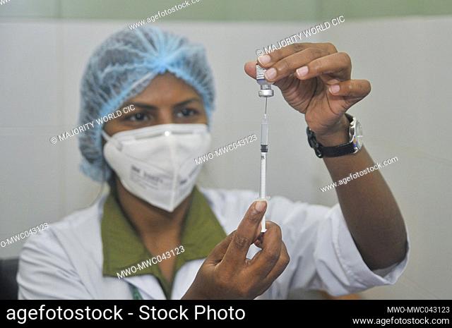 Sylhet, Bangladesh. 14th October 2021. Medical staff prepare the 1st dose of the Pfizer-BioNTech Covid-19 Vaccine at the M A G Osmani medical college & hospital...