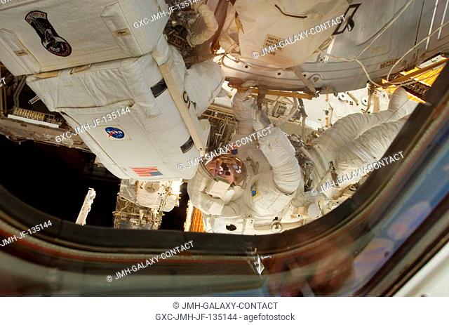 Astronauts Jim Reilly (left) and John (Danny) Olivas, both STS-117 mission specialists, are photographed by a crewmate inside the spacecraft in the midst of a 7...