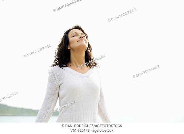 woman by the sea breathing fresh air