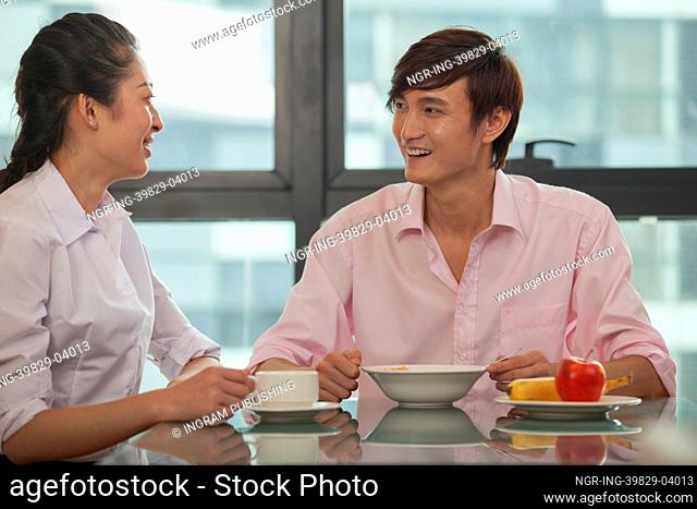 Business couple eating breakfast