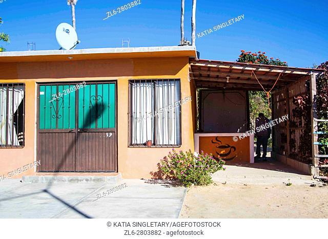 Old typical Mexican orange house with iron gates . Blue sky, sunny day in Cabo San Lucas, Baja California, Mexico