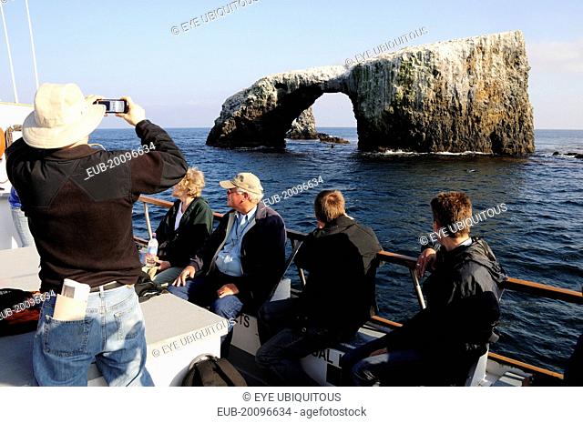 Tour boat passing Arch Rock, East Anacapa, Channel Isles