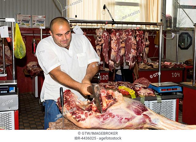 Butcher cutting meat, Samal Bazar, Shymkent, South Region, Kazakhstan, For editorial use only