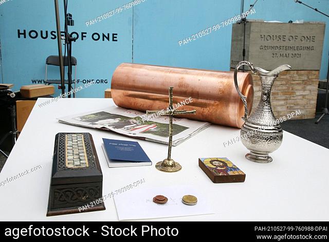 27 May 2021, Berlin: Various objects for document cases lie on the table at the laying of the foundation stone for the multi-religious building ""House of One""...