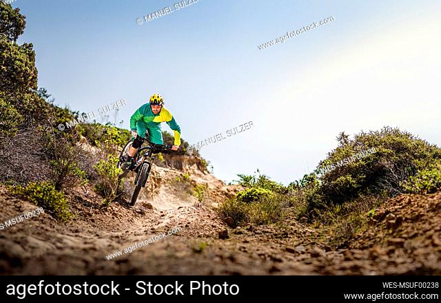Man riding mountainbike on dirt track, Fort Ord National Monument Park, Monterey, California, USA