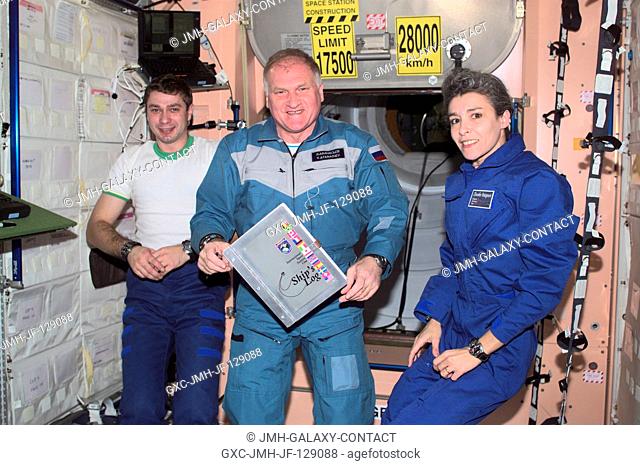 The Soyuz Taxi crewmembers, Flight Engineer Konstantin Kozeev (left), Commander Victor Afanasyev and French Flight Engineer Claudie Haignere add their names to...