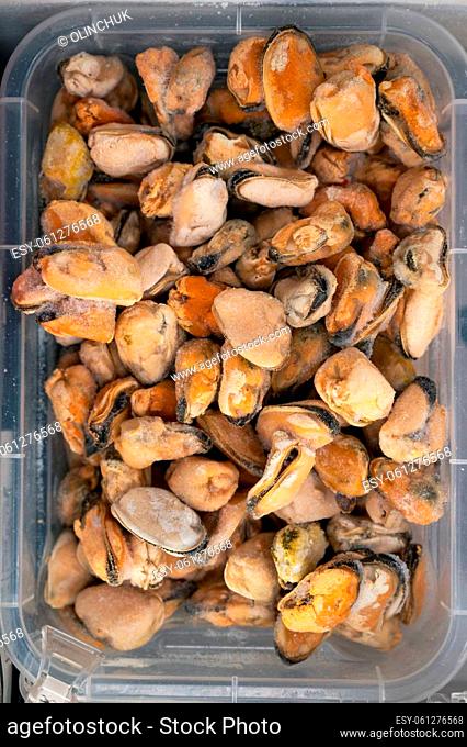 Frozen mussels in fridge at the fish market. Healthy eating and fish market concept
