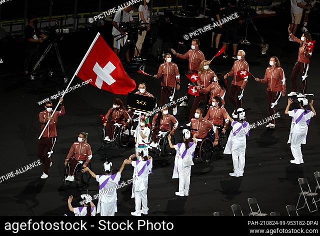 24 August 2021, Japan, Tokio: Paralympics: Opening Ceremony at the Olympic Stadium. Team Switzerland arrives at the Olympic Stadium for the Opening Ceremony