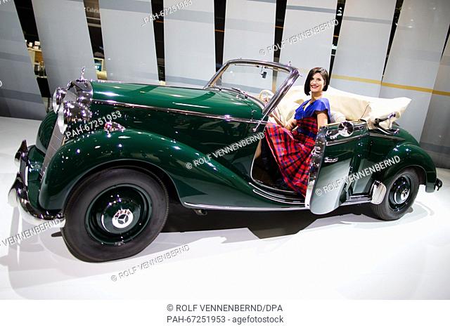 Isabel poses next to a Mercedes-Benz 170 S Convertible B from 1949 at the Techno Classica motor show in Essen, Germany, 06 April 2016