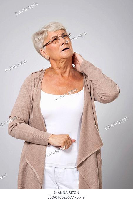 Senior woman suffering from pain of neck. Debica, Poland