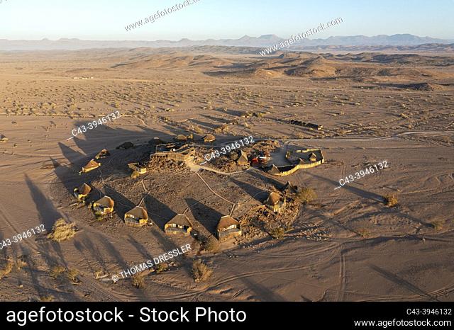 The Doro Nawas Camp and arid desert plains at the edge of the dry bed of the Aba-Huab river. Aerial view. Drone shot. Damaraland, Kunene Region, Namibia