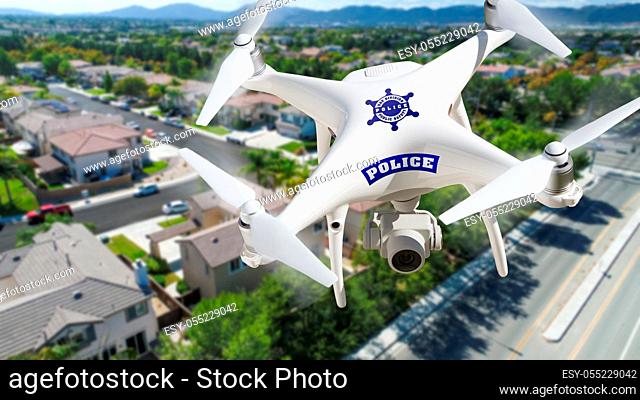 Police Unmanned Aircraft System, (UAS) Drone Flying Above A Neighborhood and Street