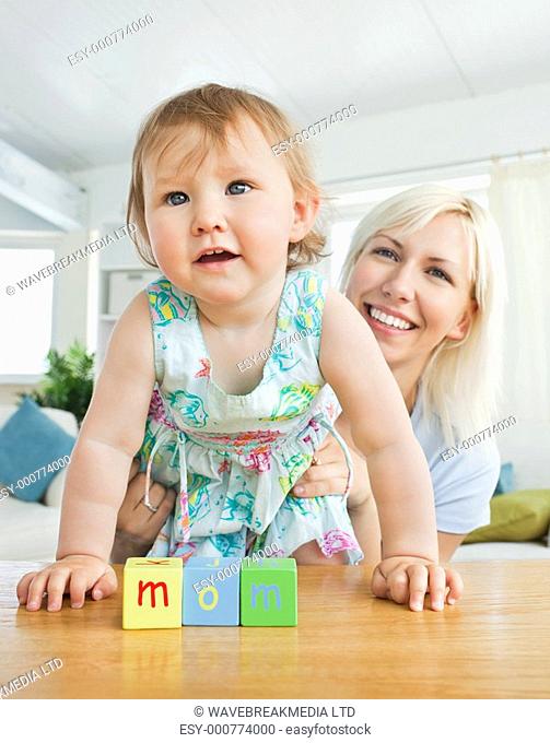 Radiant mother playing with her daughter in living room