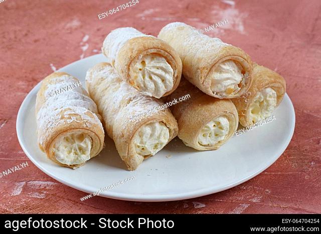 Puff rolls with vanilla cream. Delicious cream horns filled with vanilla cream