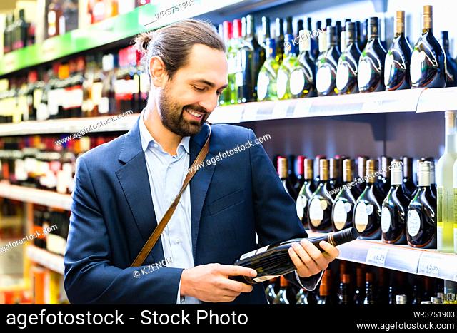 Man selecting wine in liquor store