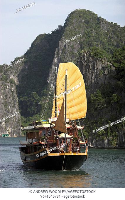 Motorized cruising junk with sails Halong Bay Vietnam