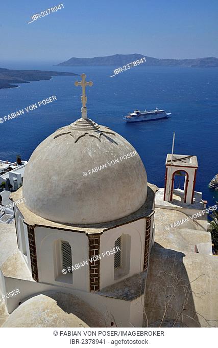 View from the crater rim across the rooftops of Firá or Thira into the Caldera, Ágios Ioánnis church at front, Santorini, Cyclades, Greek Islands, Greece