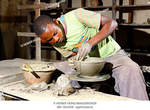 Man working at a potter's wheel producing pottery, Bamessing, Cameroon, Africa