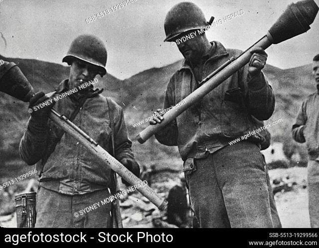 U.S. Soldiers Examine German Bazooka -- German, Bazooka, imitations of the American anti-tank guns, are examined by two U.S