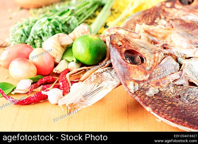 Dried fish and curry for cooking on wooden floor