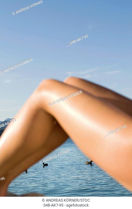 Woman's legs at a lake, Caldonazzo, Trentino, Italy
