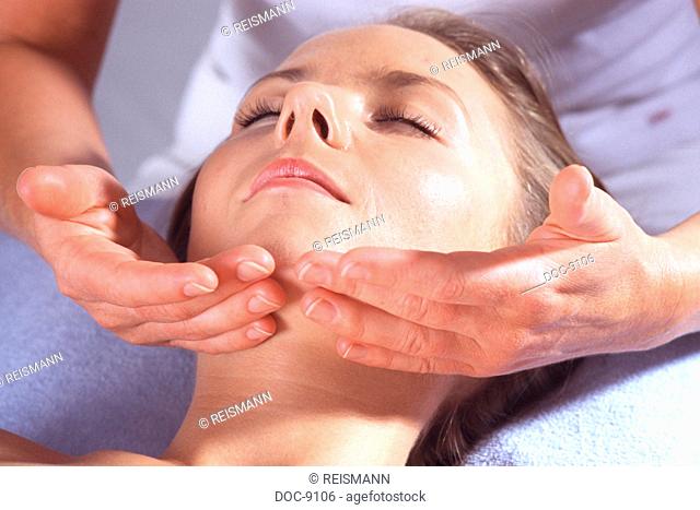 Young adult woman makes herself be spoiled through gentle manual lymphatic drainage