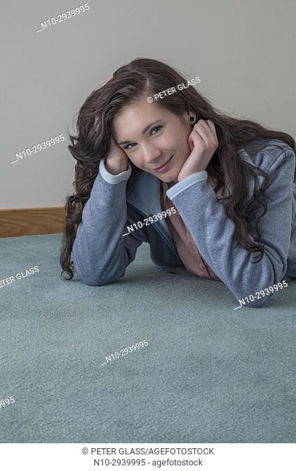 Teenage girl lying on the floor