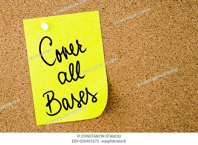 Cover All Bases text written on yellow paper note pinned on cork board with white thumbtack. Business concept image with copy space available