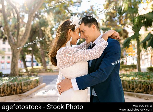 Smiling couple embracing each other in park