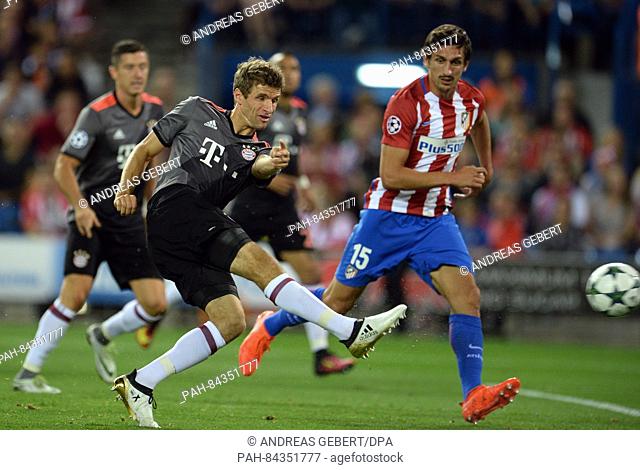 Munich's Thomas Mueller (l) and Atletico's Stefan Savic (r) in action during the Champions League Group D soccer match between Atletico Madrid and Bayern Munich...