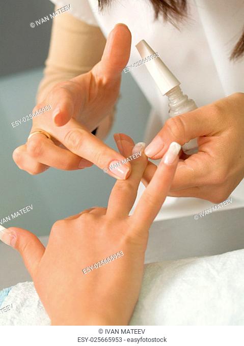 Girl fingernails being manicured