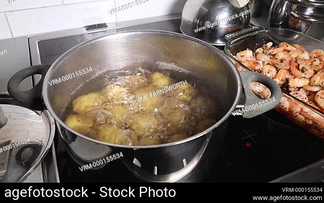 Potatoes boiling in a pan of water
