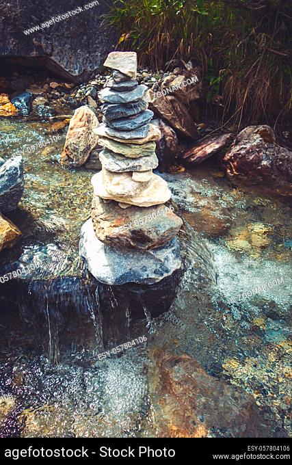 Cairn on a river in Vanoise national Park valley, Savoy, French alps