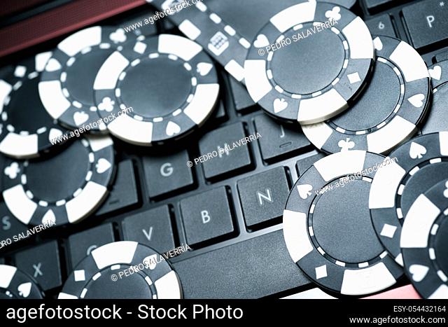 Casino chips stacking on a laptop