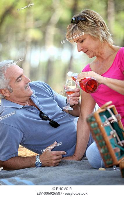 Middle-aged couple having fancy picnic