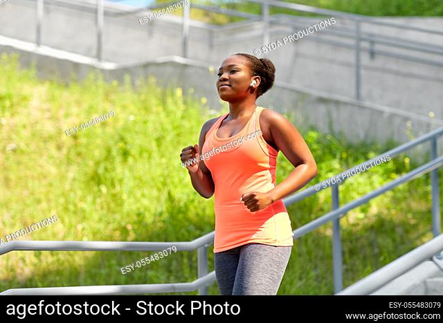 african american woman running outdoors