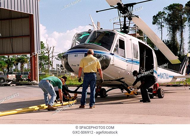 10/25/2000 -- A NASA UH-1H helicopter is prepared for transfer back to Patrick Air Force Base after being painted. The blades of four NASA UH-1H helicopters...
