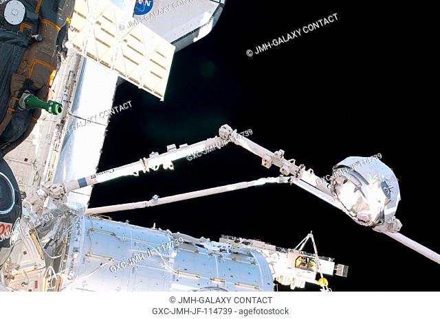 In the grasp of the Canadarm2, the Cupola is relocated from the forward port to the Earth-facing port of the International Space Station's newly-installed...