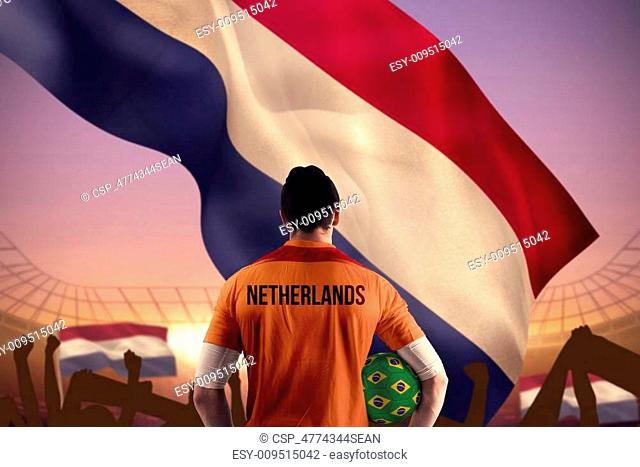 Composite image of netherlands football player holding ball