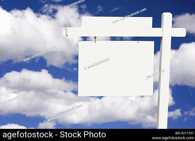 Blank real estate sign on clouds & sky background, ready for your own message