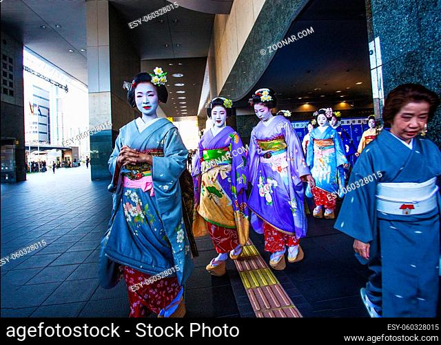03-26-2015 Kyoto, Japan. Pupils of geisha next to station Kyoto. I n traditional Kimono and getya (wooden shoes). Editorial
