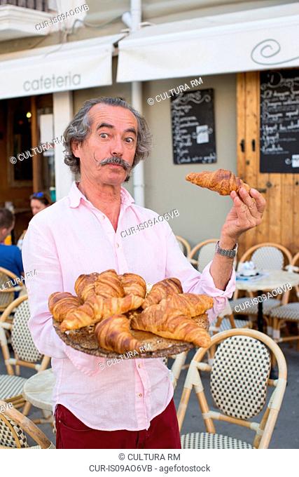 Portrait of eccentric croissant seller, Ibiza, Spain