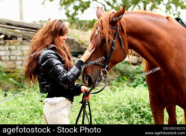 Woman and her beautiful brown horse