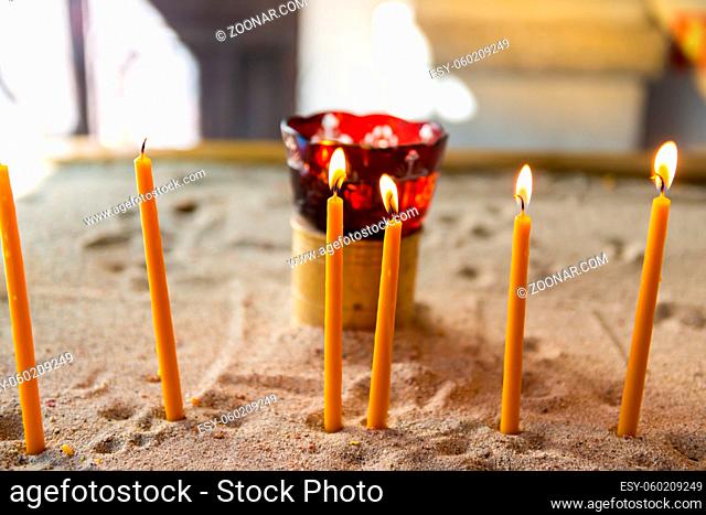 Candles light in church, candle flame in temple