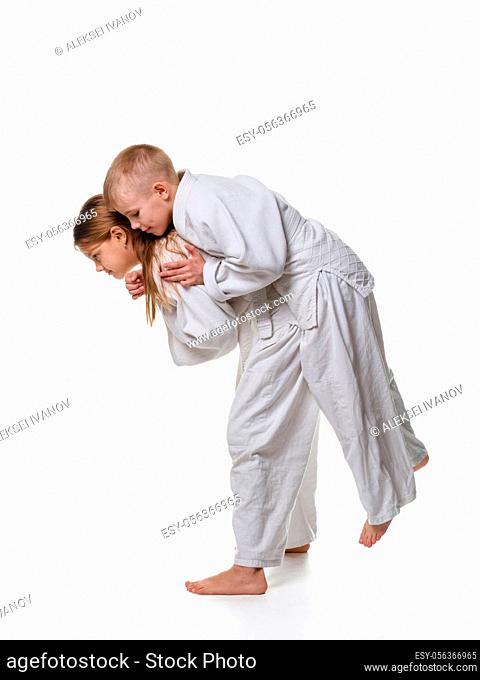 Judo student girl learns to perform throw through the thigh